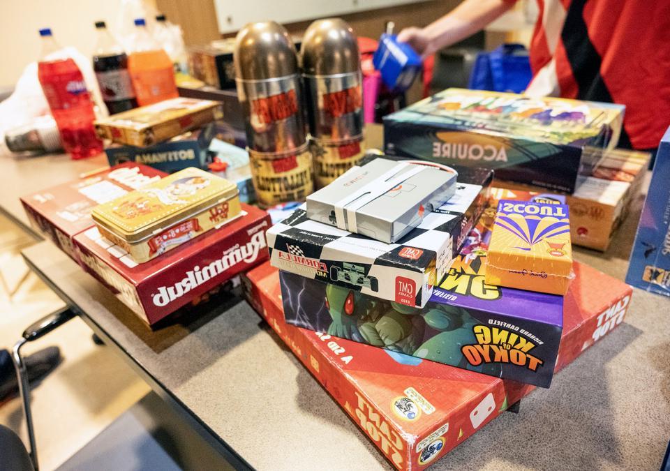 A table piled with board games.